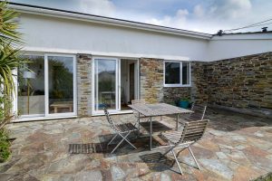 Rear patio at The Ridings with glass doors into the open plan dining and kitchen area