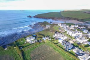 Aerial view over the beach and ocean and the coastline towards Padstow