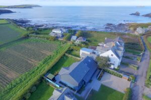 Aerial view of Torridon over the ocean with Trevose Head in the background