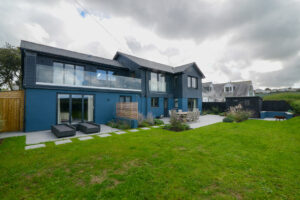 The rear grassed lawn and rear exterior of Torridon