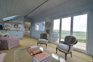The first floor sitting room at Torridon with large folding glass doors onto the balcony