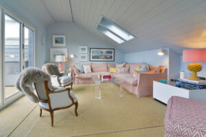 The first floor sitting room at Torridon with large doors to the balcony ample comfortable seating and Velux windows