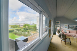 The first floor sitting room at Torridon with large folding glass doors onto the balcony
