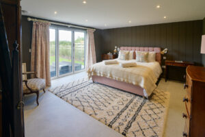 Ground floor master ensuite superking bedroom at Torridon with doors out onto the patio and rear garden