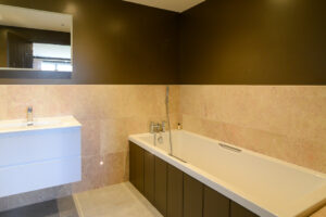 The ensuite off the master bedroom at Torridon with bath which has a hand held shower attachment