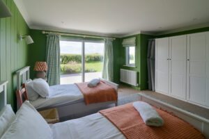 Ground floor twin bedroom at Torridon with access to the rear patio