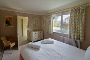 Ground floor king bedroom at Torridon with window to the front of the house