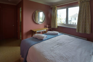 First floor ensuite king bedroom at Torridon with window to the front of the house