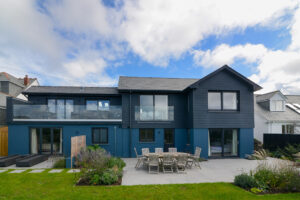 Rear exterior of Torridon showing the split patio accessed from the the master bedroom both the ground floor twin bedroom and utility room