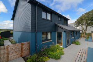 Front exterior at Torridon with paved area and access to the side of the house to the rear garden