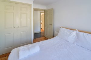 The double bedroom at Tregarne with built in wardrobes and door to the entrance hall