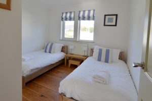 The twin bedroom at Tregarne with window to the front of the property