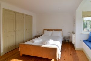 The master king ensuite bedroom with bedside tables at Tregarne