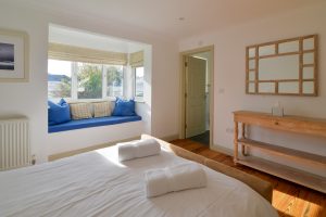 The master king ensuite bedroom at Tregarne with window seat