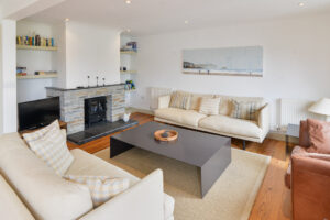 The lounge at Tregarne with seating and wood burner