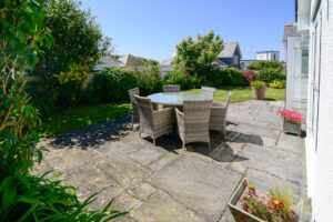 Outside dining furniture on the rear patio at Tregarne