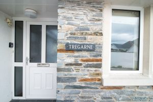 The house name sign by the front door at Tregarne
