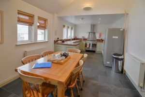 The open plan kitchen and dining area at Tregarne with appliances and kitchen table and chairs