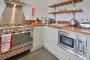 The large gas over and microwave in the kitchen at Tregarne