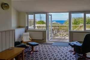 Double doors onto decking from the ground floor garden room at Wispa