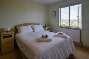 King sized bedroom on the first floor a Wispa with sea views