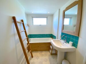 Ground floor bathroom at Sunset showing bath and wash basin