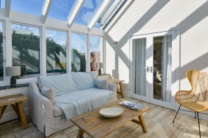 Conservatory at Sunset with double doors into the house