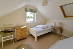 First floor single bedroom at Sunset with sloping ceiling