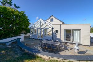 Rear exterior of Sunset with patio and outside dining furniture