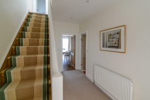 Hallway and stairs to first floor at Sunset
