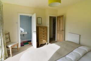 Ground floor ensuite superking bedroom at Sunset with door into ensuite which has a shower toilet and wash basin