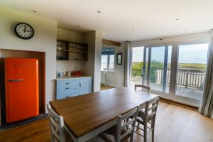 Kitchen and dining area at Sunset with large sliding door onto the balcony