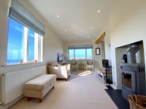 Large lounge off the kitchen and dining area at Sunset with wood burner