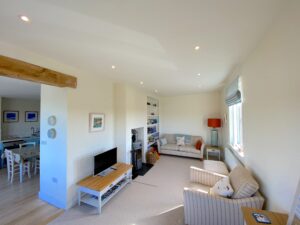 Large Lounge at Sunset with seating and wood burner