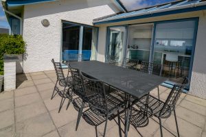 Outdoor dining area on patio at Atlantic Breezes with seating for eight