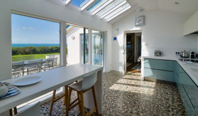 Well equipped kitchen with bar stools and sea views at Atlantic Breezes