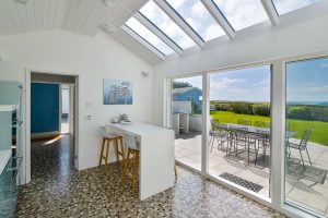 Kitchen at Atlantic Breezes with views of the sea and large garden through glass doors