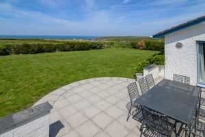 Rear garden with patio and large grassed area at Atlantic Breezes