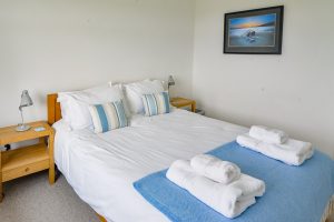 King sized bed in ground floor bedroom at Atlantic Breezes
