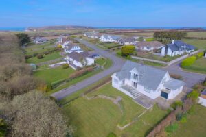 Aerial view of Herongate showing rear of house, rear garden and view towards Trevose Head