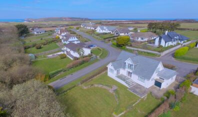 Aerial view of Herongate showing rear of house, rear garden and view towards Trevose Head