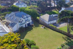 Aerial view of the grassed rear garden and house at Sailaway