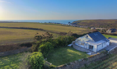Aerial view over Sunset with Porthcothan Bay and coastline in the background