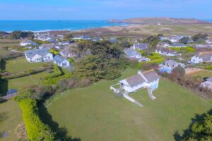 Aerial view of Thalassa and the large wrap around garden and views toward Trevose Head