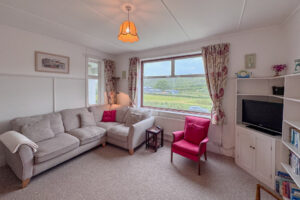 Lounge seating at Wings with window to the front of the house