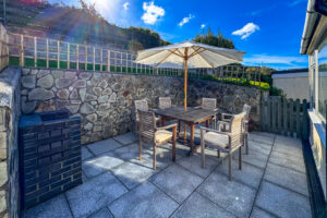 Rear patio area with bult in barbeque and outside dining table and chairs