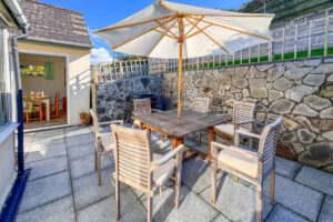 Rear patio area with built in barbecue, outside dining table and chairs