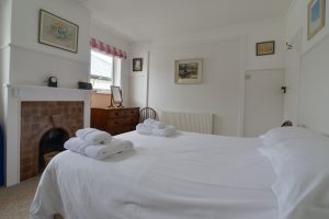 Double bedroom at Wings with feature fireplace.