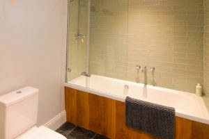 Bathroom with bath tub and overhead shower at The Studio at Pensile House