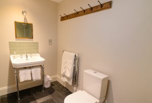 Bathroom with basin and loo at The Studio at Pensile House